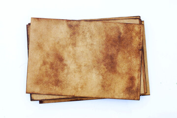 Pile of old brown paper grunge background. Abstract liquid coffee color texture.