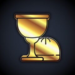 Gold Holy grail or chalice icon isolated on black background. Christian chalice. Christianity icon. Vector.