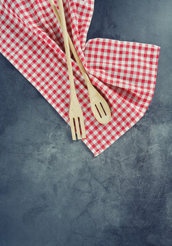 Red Kitchen Towel And Wooden Spoons