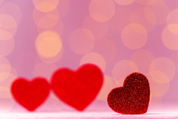 Red heart decoration against pink bokeh background