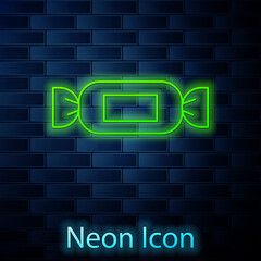 Glowing neon line Candy icon isolated on brick wall background. Vector.