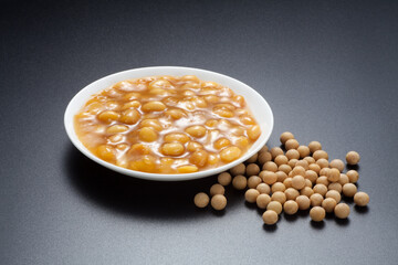 Soybean paste in a dish on black background.