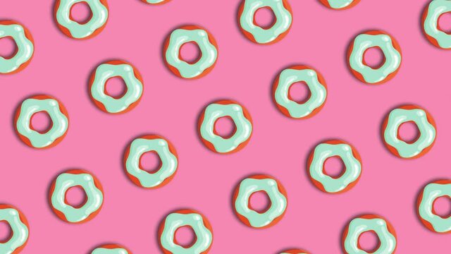 donuts on pink background in a pattern rotation loop animated background 4K