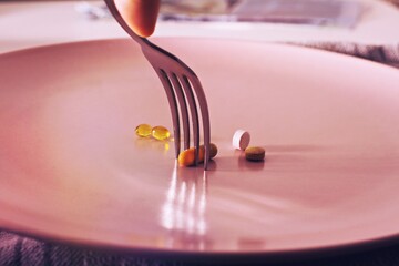 close up of pills on a plate concept of food problems or vitamins