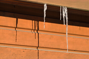 Icicles hang from a house wall