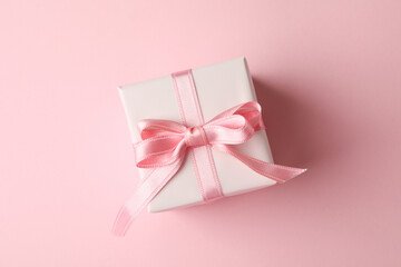 Gift box on pink background, top view