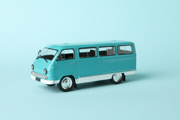 Toy bus on blue background, close up and space for text