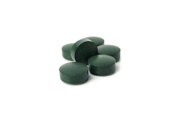 Spirulina in pills isolated on white background