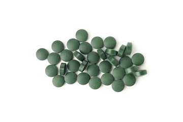 Heap of spirulina pills isolated on white background