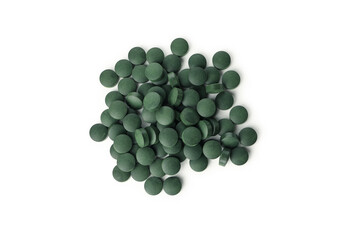 Heap of spirulina pills isolated on white background