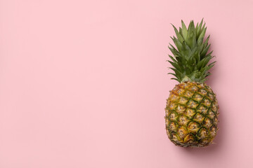 Tasty ripe pineapple on pink background, space for text