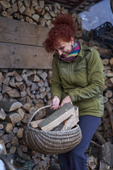 Woman carrying a basket with firewood