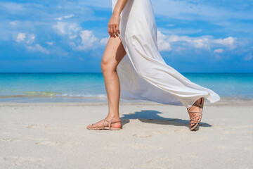 Fototapeta na wymiar woman legs walking on sea beach at Koh MunNork Island, Rayong, Thailand