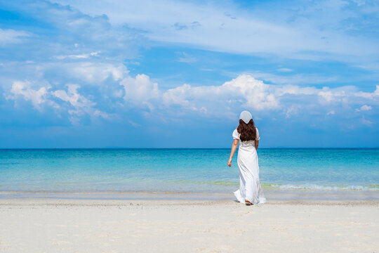 cheerful woman walking on sea beach at Koh MunNork Island, Rayong, Thailand