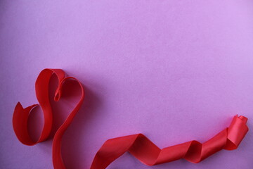 Obraz na płótnie Canvas heart of red ribbon on pink background with copyspace place for the text of the background Valentine's Day lovers