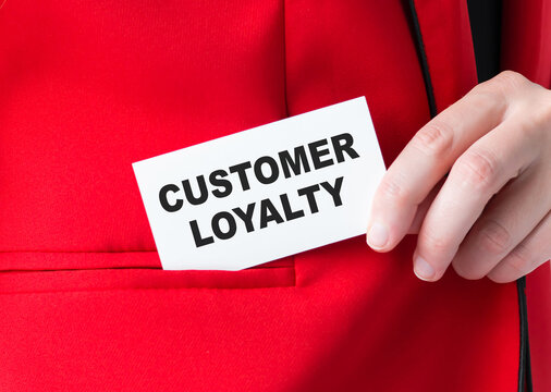 Customer loyalty card in businessman hands, which he puts into the korman of the red jacket