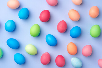 Colorful Easter eggs on blue background top view