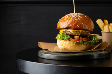 Close up of burger on black table