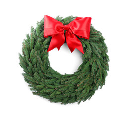 Christmas wreath made of fir branches with red bow on white background, top view