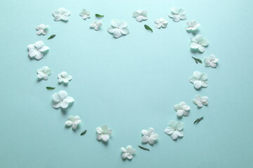 White hydrangea petals arranged in love heart shape