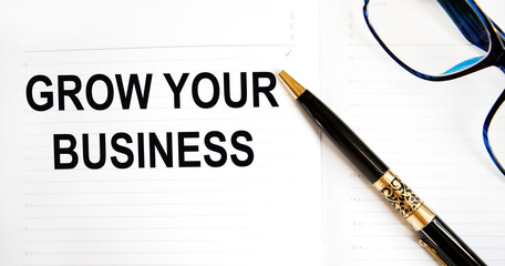 In the diary, the text of GROW YOUR BUSINESS, next to the pen and glasses.