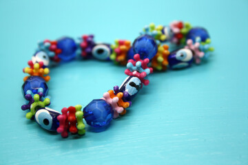 A bracelet made of beads on a blue background.
