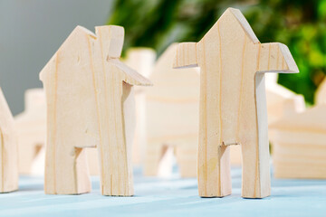 Wooden house miniature on wooden surface close up