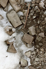 construction debris makes its way through the melted snow