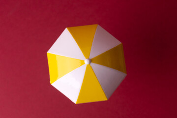 colorful beach umbrella on red background