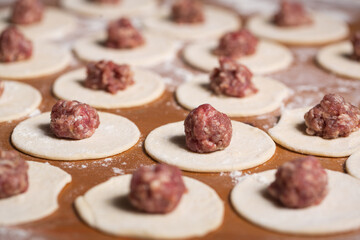 Dumplings making process, dough and minced meat
