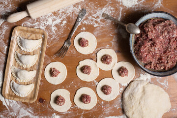 Dumplings making process, dough and minced meat