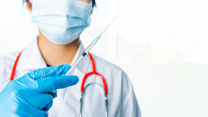 Doctors or scientists are carrying syringes with liquid vaccines for young and old to. prevent...