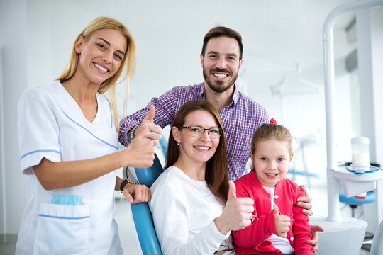Satisfied family with a smiling young female dentist