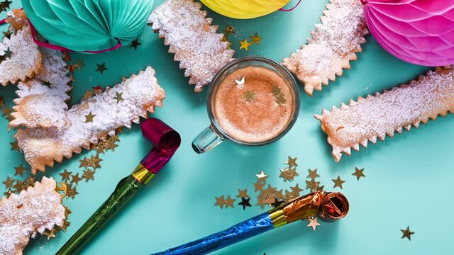 Carnival italy. Fragrant espresso in a bright mug and  called crostoli on a blue background.  Delicious carnival sweets typical of the Italian tradition chiacchere.  FullHD footage. Stop motion