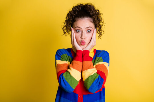 Adorable lady arms cheekbones send air kisses shy hide rose cheeks wear rainbow pullover isolated yellow color background