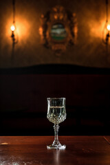 A vintage glass of white wine in a bar