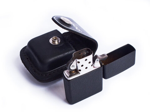 Zippo lighter with black leather case isolated on white. Moscow, Russia - March 2019