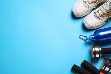 Flat lay composition with sport items on blue background. Space for text