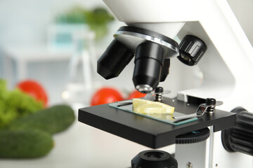 Slide with slice of lemon on microscope in laboratory, closeup. Poison detection