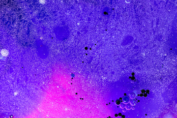Dark purple background with paint drops, macro