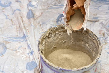 kneading cement mortar in saucepan. preparation for repair