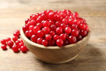 Ripe fresh cranberry on wooden table, closeup