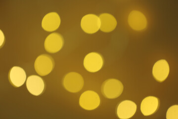 Blurred view of beautiful lights on color background