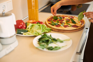 Final touch in making pizza at home before serving it