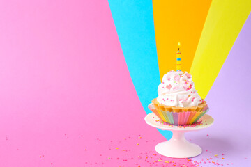 Delicious birthday cupcake with candle on color background. Space for text