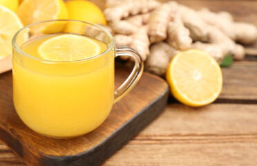 Immunity boosting drink and ingredients on wooden table, closeup. Space for text