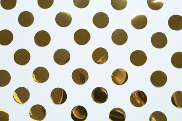 Shiny golden confetti on white background, flat lay