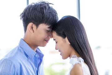Valentine's day concept,portrait of asian Young happy couple face to face kissing at home background,copy space,Love story couple