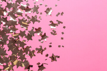 Shiny confetti on pink background, flat lay. Space for text