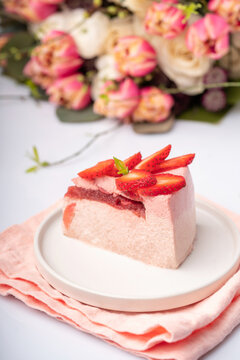 Strawberry cake on withe dish with berries and flowers on the table for Valentin's day or birthday party. High quality photo